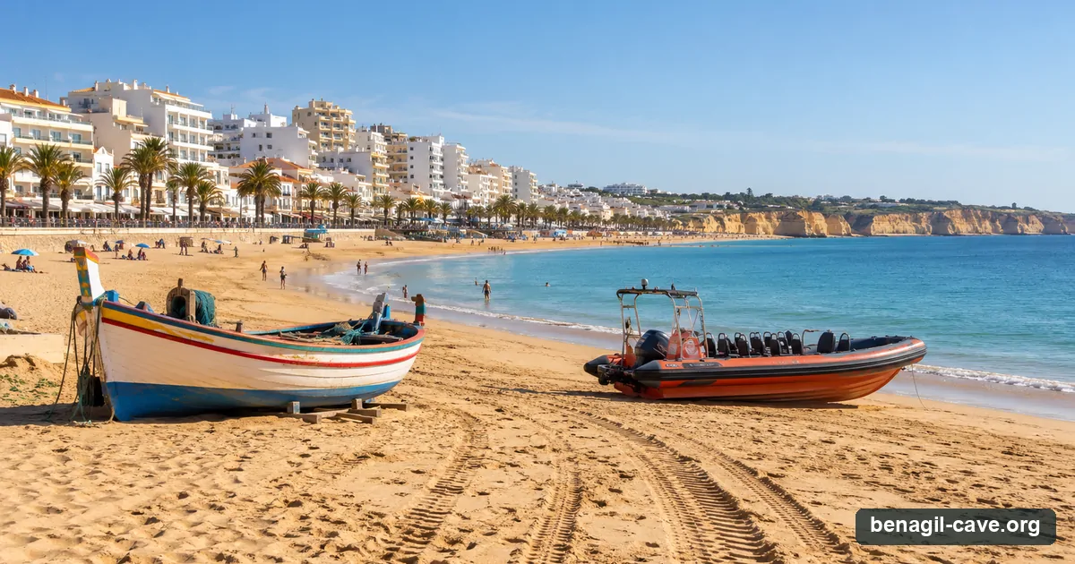 A painted fishing boat and a tour RIB on the sand at Armacao de Pera, the closest big beach to Benagil