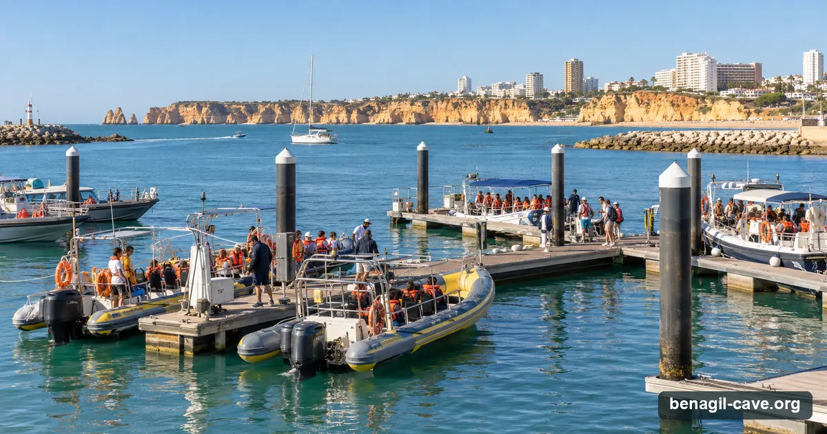 Speedboats loading passengers at Portimao marina with the Praia da Rocha cliffs beyond