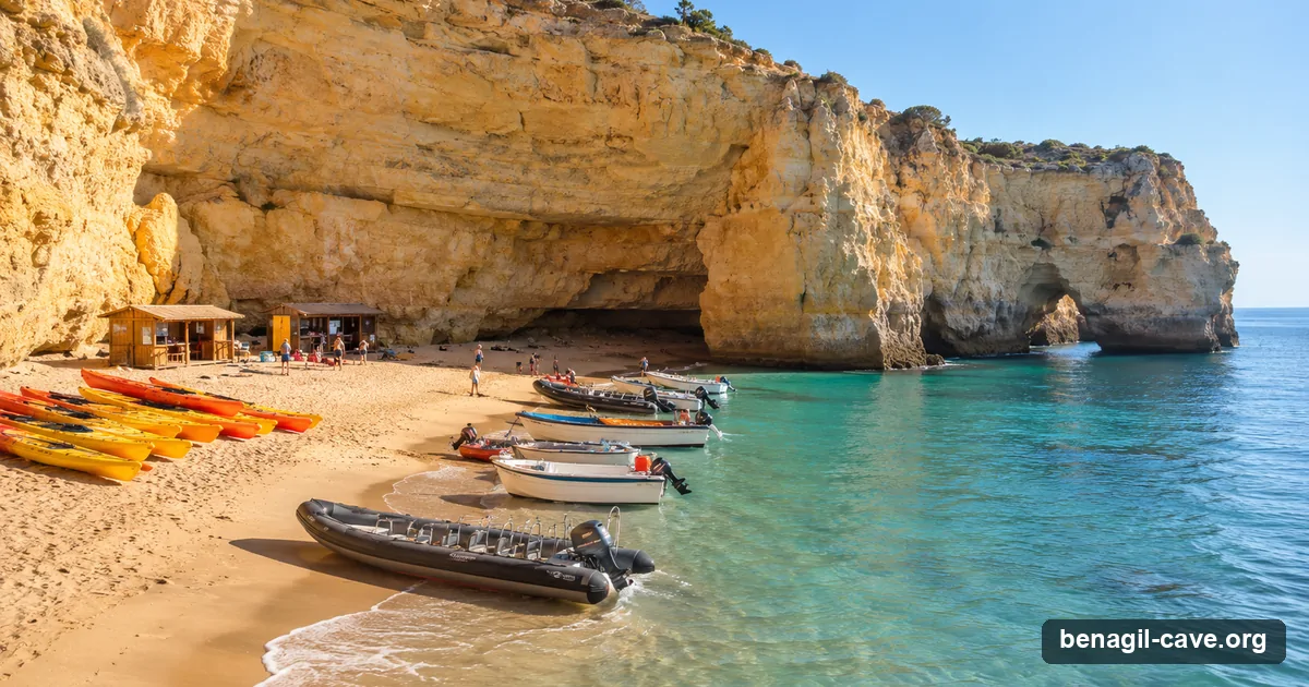 Tour boats and kayaks lined up on Benagil beach in the early morning before the first departures